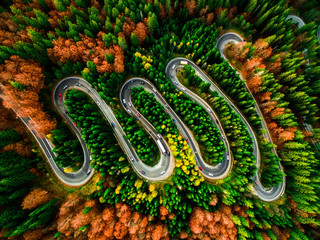 Beautiful aerial view of a curvy winding road with serpentine and colorful autumn trees, Cheia, DN1A, Romania