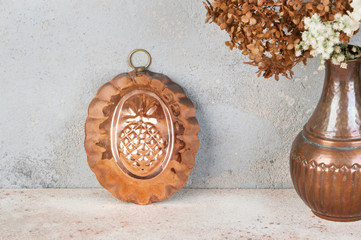 Vintage copper mold on a concrete background.