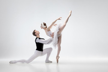 Kiss. Graceful classic ballet dancers dancing isolated on white studio background. Couple in tender...