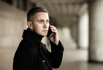 Stylish man in black trenchcoat