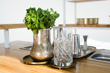 Vase with mint on the table in the kitchen. Kitchen interior design. Summer drink.