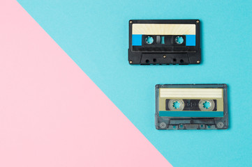 Retro audio cassette tapes on colorful background. Vintage music technology concept.