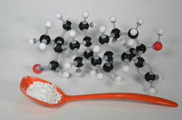 Molecule model of Stevia, the central element in a natural sweetener with sample in an orange...