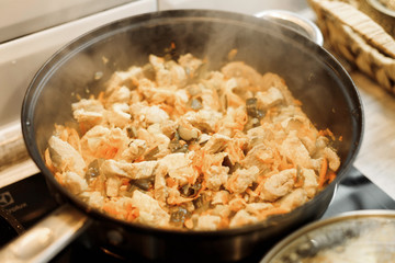 Grilled meat. Hot pan with a side dish. Tasty food. The process of cooking.