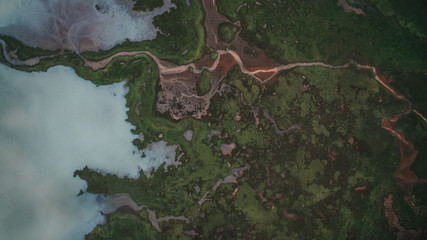 Aerial view river flows into a lake in Highlands of Iceland. Beautiful green patterns all over Iceland.