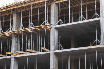 Washing of gas cooker with yellow sponge and soap detergent. Soap foam on black hob. Cleaning service concept. Close up