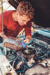 The concept of disability of people and their adaptation to life.A disabled person pours engine oil...