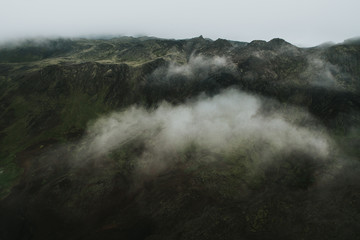 Drone view of a mountain above the clouds on a foggy day, Iceland.