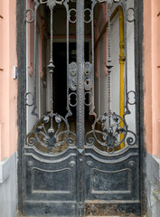 Beutiful forged metal gates at building entrance of old european town