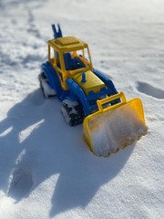  toy tractor in the snow in winter