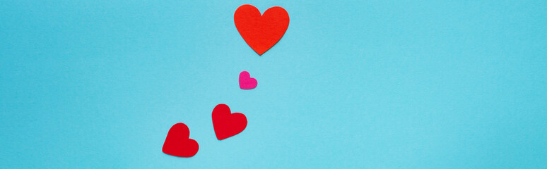Top view red paper hearts of isolated on blue, panoramic shot