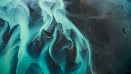 Aerial view from above on a green and blue glacier river stream in  South Iceland. Beautiful...