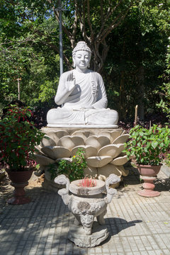 white buddha statue in a temple in asia against a blue sky