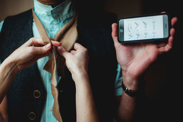 Step-by-step instructions on how to tie a tie. The bride ties a groom a tie for the wedding.