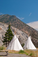 Row of beautiful cabins in a form of traditional indian tipi over gorgeous mountain view.