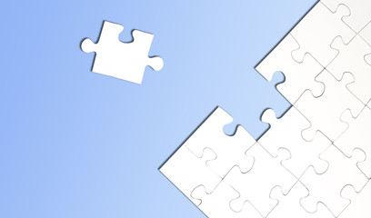 top view of jigsaw puzzle with one piece left on light blue background, completing a task or...