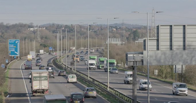 Denham, UK - January 10 2020: Medium shot looking east towards vehicles on the busy M40 near to Denham