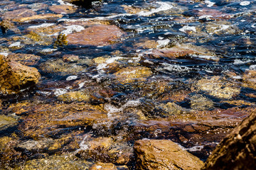 river with a stream and pebbles.pebbles at the bottom of the river