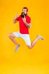 Fototapeta na wymiar excited bearded man jumping. full of energy. Impetuous movement. dedicated to sport and fitness. active runner in move. Always in motion. Success and happiness