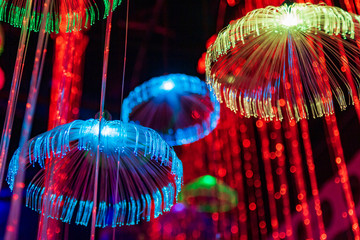 Red blue neon garlands of bokeh lights and reflections.