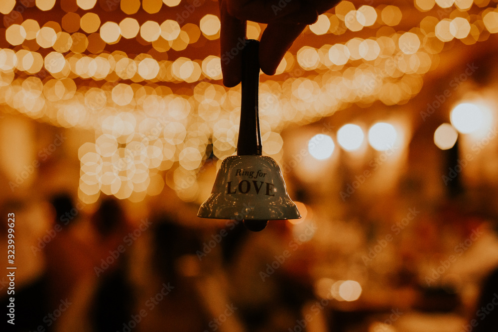 Wall mural ring the bell for love with a beautiful bokeh in the background. wedding accessory.