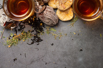 cups of tea and dried fruits and place for text on a gray background