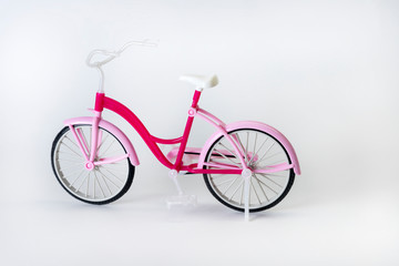 pink bicycle with basket on a white background