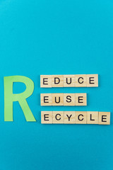 Reduce, reuse, recycle ecology minimalistic concept. Isolated wooden letter blocks with word cloud Ecology 