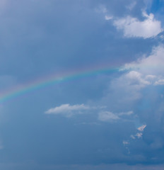 Fototapeta na wymiar Rainbow after rain on a hot summer day in Sochi