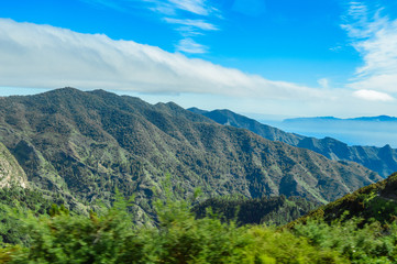 Fototapeta na wymiar Green Slopes Falling Over The Valley In The Mist Of The Summit In La Gomera. April 15, 2019. La Gomera, Santa Cruz De Tenerife Spain Africa. Travel Tourism Photography Nature.