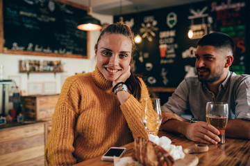 happy couple eating in fast food corner