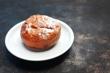 Donut, traditional iced donut with filling. Sweet cake, yeast dough donut fried in deep oil.