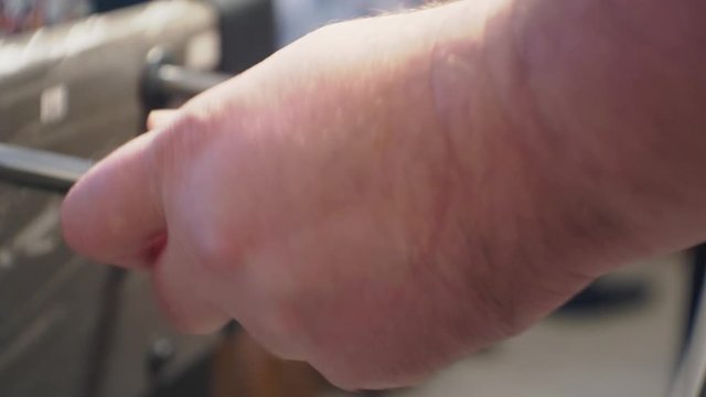 male hands actively move the table football or kicker control knobs