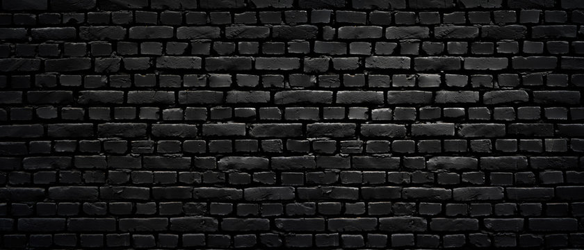 Texture of a perfect black brick wall as background or wallpaper