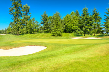 Golf course with gorgeous green and sand bunker