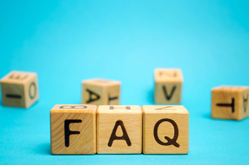 Wooden blocks with the word FAQ (frequently asked questions). Collection of frequently asked...