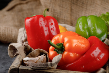 Red, orange and green color bell peppers.