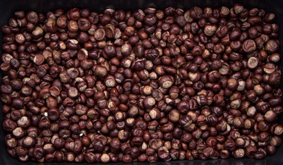 Top view heap of chestnuts. Pile of ripe chestnuts for food background