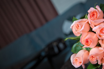 Background with violet ,pink roses on a black marble background . Pink peonies flower bouquet for text .