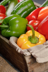 Bell peppers in a wooden rustic tray.