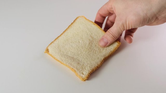 Sliced white bread on white kitchen table. Close up.