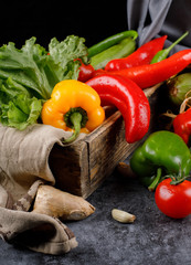 Chili peppers and lettuce in a wooden tray.