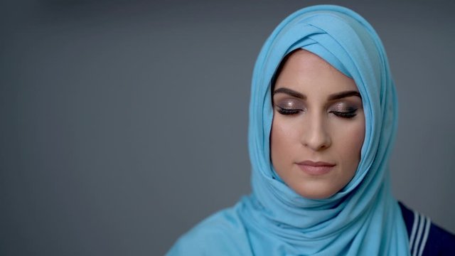 Female muslim student learning at home