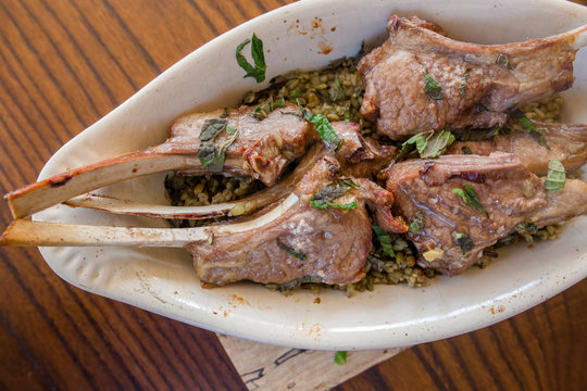 Close-up view of Lebanese lamb chops and fresh mint with freekeh