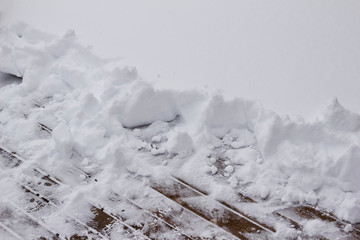 Abstract texture view of newly shoveled deep snow on a wooden deck floor surface, with copy space