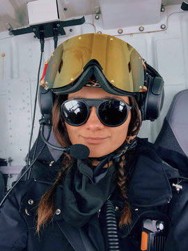 A confident woman smiles while heliskiing in the mountains of Chile.