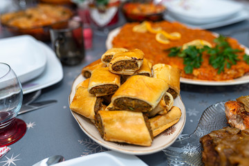 Baked pate in a pie lying on a holiday table on a plate.