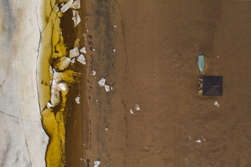 beachguard hut and boat at beach near melting ocean ice