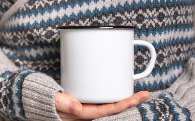 Enamel Mug with black edge line Mock-up. Girl holds white old-tin campfire cup in her hands