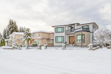 A perfect neighborhood. Houses in suburb at snow winter in the north America.